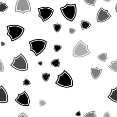 Seamless vector pattern with shield symbols, creating a creative monochrome background with rotated elements. Vector illustration on white background