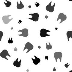 Seamless vector pattern with tooth symbols, creating a creative monochrome background with rotated elements. Vector illustration on white background