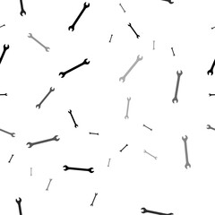 Seamless vector pattern with wrench symbols, creating a creative monochrome background with rotated elements. Vector illustration on white background
