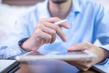 Closeup hand pen writing black screen background digital tablet technology work office business person, online internet job businessman using planning stylus electronic device note document