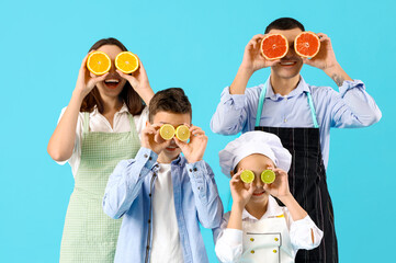 Happy family with citruses on blue background