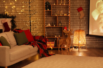 Interior of living room with Christmas lights, sofa and projector screen