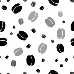 Seamless vector pattern with hockey pucks, creating a creative monochrome background with rotated elements. Illustration on transparent background