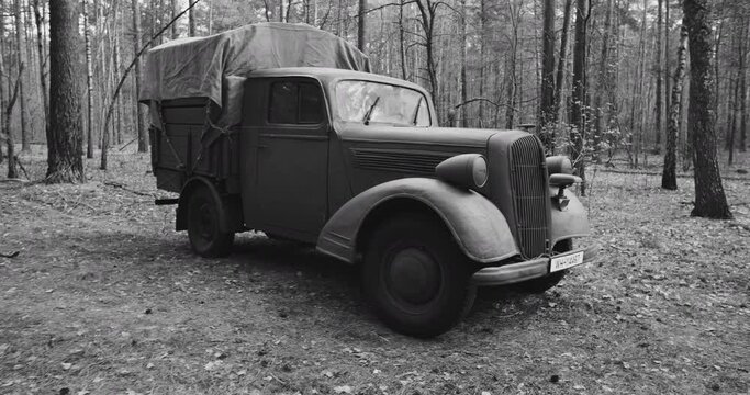 German Vehicle Truck Opel Blitz In Forest. Sunny Autumn Day. Military Truck Opel. German Wehrmacht World War Ii Military Automotive. Autumn Season Nature. Reenactment Tactic Game. Black And White