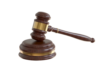 A wooden judge gavel. Auction hammer with gold on the stand. Law and justice system symbol