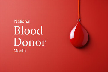 January national blood donor month concept. Pendant drop of blood and text on a red background, poster - obrazy, fototapety, plakaty