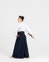 Aikido master woman in traditional samurai hakama kimono with black belt with sword, katana on...