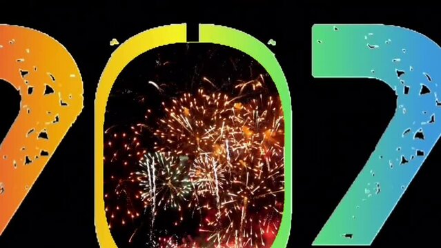 Explosion of smoke and sparkling particles of rainbow colors, generate text Happy New Year 2024, zoom in fireworks video at the night sky.