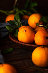 Tangerines in a plate on a wooden table