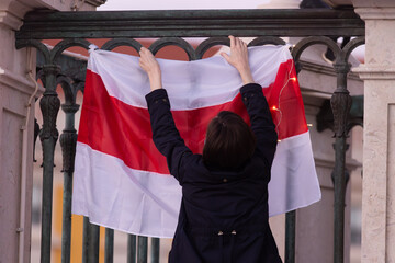 Woman with white red white flag of Belarus resistance - visit of opposition in Lisbon