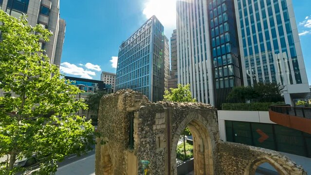 Ultra wide angle shot featuring the ruins of a Roman fortification adjacent to modern office buildings in London Wall, England
