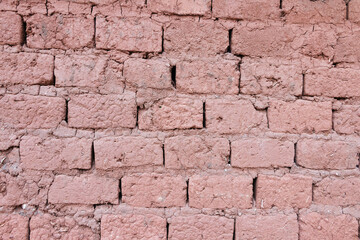 Old adobe mud brick wall in frontal view