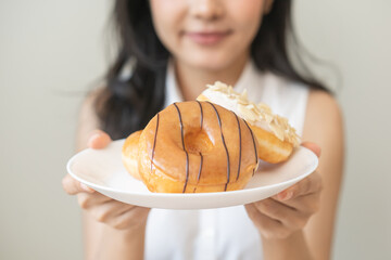 Close up donut plate with happy smile asian young woman, girl temptation food, enjoy eating sugar...