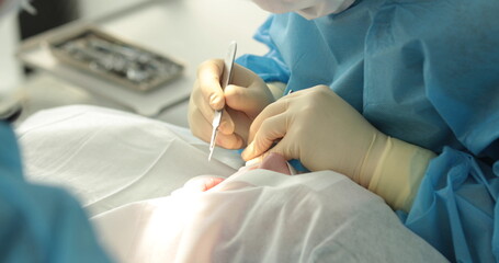 Obraz na płótnie Canvas Dental treatment close-up. A dentist performs a dental procedure. Dentist's hands at work. Oral cavity in the process of treatment at the dentist.