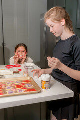 Teen Sisters Making Valentine's Day Cookies, vertical