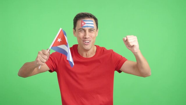 Man cheering for Cuba screaming and waving a national flag