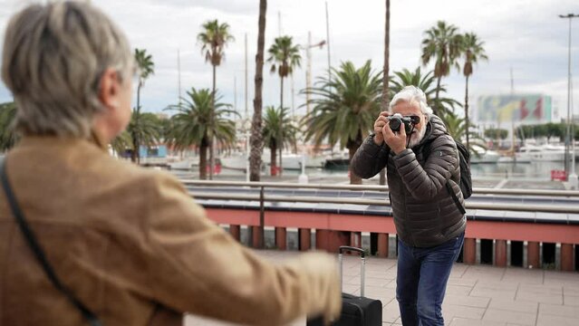 Senior tourist photographing his wife on travel destination on vacations 