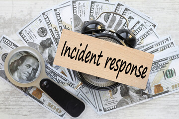 Incident response. a lot of bills on the work table. table clock and text on a wooden block