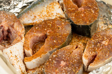 raw yellow-tailed fish during cutting for cooking