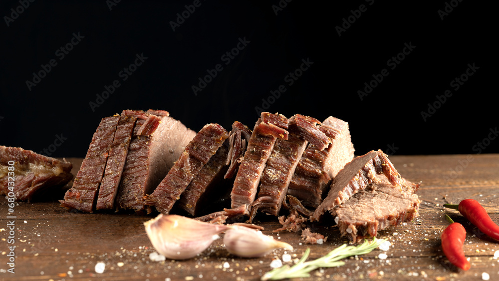 Wall mural meat with spices on a wooden background