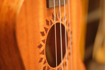 Ukulele close-up, selective focus on yellow guitar