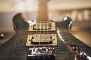 Closeup of black electric guitar with shallow depth of field