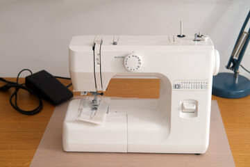 Sewing machine in the workshop. Workplace of seamstress.