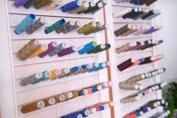 Colorful sewing threads in a tailor shop. Selective focus.