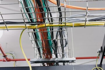 With so many wires and cables, it's easy to get lost in the web of connections. The ceiling of the server room is lined with cable trays to keep the cables organized.