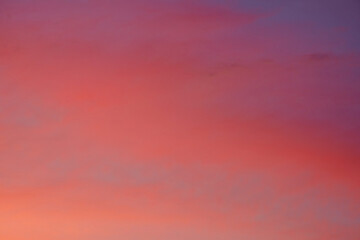 The cloudscape during the evening was filled with layers of bright red and yellow clouds, illuminated by the warm sunlight.