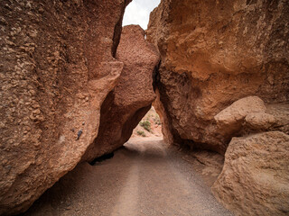 Driving through large stones at the bottom of the Valley of Castles. Charyn Canyon National Park. A small replica of the US Grand Canyon