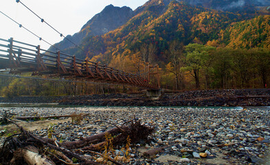 Scenery of Myojin bridge and Azusa river in late autumn at Kamikochi National Park, Matsumoto, Nagano, Japan