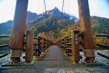 Scenery of Myojin bridge and Azusa river in late autumn at Kamikochi National Park, Matsumoto, Nagano, Japan