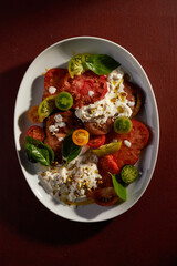 salad with different varieties of tomatoes and strachiatella
