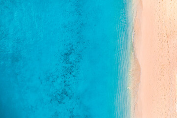 Summer seascape beautiful waves, blue sea water in sunny day. Top view from drone. Sea aerial view, amazing tropical nature background. Beautiful bright sea waves splash crash beach sand  landscape