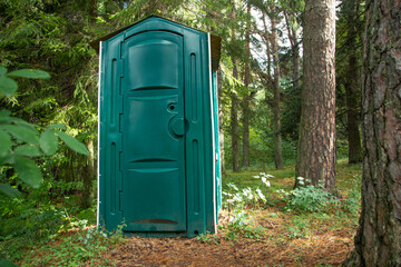 Fototapeta na wymiar Outdoors toilet in green forest.