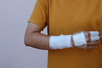 The woman wore a yellow shirt and had a bandage wrapped around her hand. After being injured while...