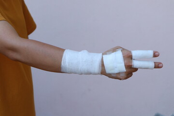 The woman wore a yellow shirt and had a bandage wrapped around her hand. After being injured while cooking