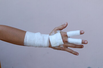 The woman wore a yellow shirt and had a bandage wrapped around her hand. After being injured while cooking