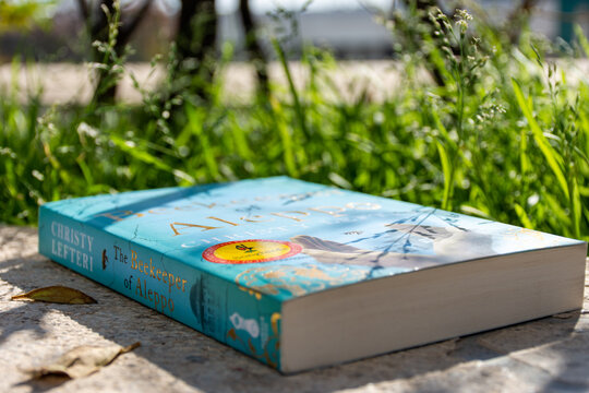 Close-up Christy Lefteri's The Beekeeper of Aleppo novel in the garden.