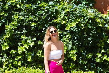 Young and beautiful brunette woman with blonde and latin hair is on holiday in seville. The woman...