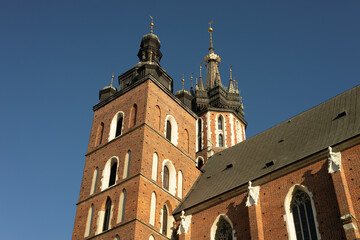 Fototapeta na wymiar St. Marys Basilica at the Main Square in the Old Town, Krakow, Poland. Detail of domes of Gothic Saint Mary Basilica. Traveling Europe