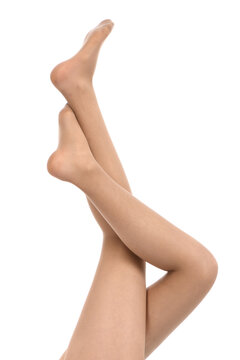 Legs of beautiful young woman in beige tights isolated on a white background.