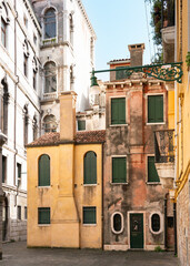 Old Venetian houses in pastel colours among large marble palaces