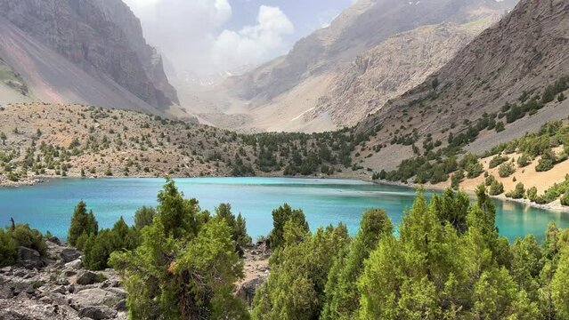 The Alaudin (Chapdara) lakes, lying at an altitude of 2800 m, are considered one of the most beautiful lakes of the Fan Mountains. Turquoise mountain lake. Pamiro-Alai. Tajikistan, Pamir 4K