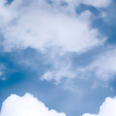 Obraz premium Soft and fluffy white clouds on a blue sky background Natural and calming Ideal for creating a serene and peaceful atmosphere in designs