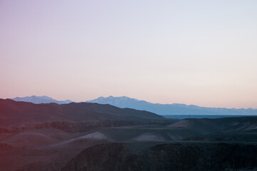 Picturesque wilderness of Kazakhstan with silhouettes of hills and mountains at sunset