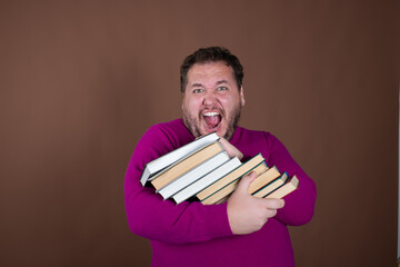 Funny librarian and important books. A man posing against a brown background.