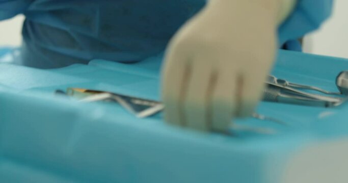 Doctor's hands with a working tool. Preparation and process of dental treatment. Dental instrument in the office of a modern dentist. Close-up in 4K, UHD