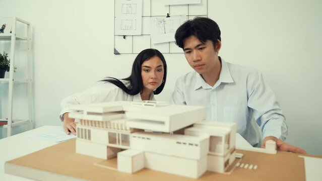 Professional smart cooperate architect engineer team checking house structure at modern office with blueprint while young beautiful project manager taking a note. Creative design concept. Immaculate..